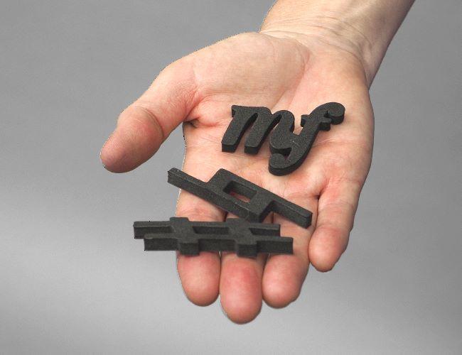 Profile view of notation magnets shown on someones hand